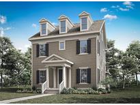 Charming three-story home with dormer windows, black shutters, and a covered front porch at 1896 Seawall Way, Celebration, FL 34747