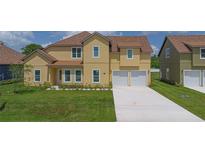 Charming two-story home with a lush green lawn and attached two-car garage at 1919 Sipes Ave, Sanford, FL 32771