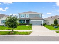 Beautiful two-story home with a well-maintained lawn and inviting curb appeal at 2355 White Lilly Dr, Kissimmee, FL 34747
