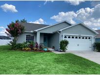 Charming single-story home with a well-manicured lawn and beautiful landscaping at 2650 Autumn Creek Cir, Kissimmee, FL 34747
