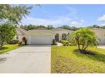 Charming single-story home featuring a well-manicured lawn and attached two-car garage at 3017 Glin Cir, Ormond Beach, FL 32174