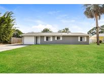 Charming single-story home with a well-manicured lawn and attached one car garage at 3312 Victory Palm Dr, Edgewater, FL 32141