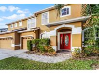 Charming two-story home with a well-maintained front yard and inviting red front door at 7621 Brightwater Pl, Oviedo, FL 32765