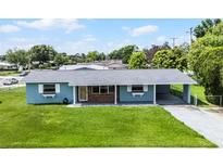 Charming single story home featuring a well maintained lawn, inviting entrance, and covered parking at 10800 Fernando St, Orlando, FL 32825