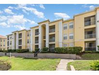Well-maintained condo building with lush landscaping and multiple balconies under a partly cloudy sky at 1125 Lake Shadow Cir # 5308, Maitland, FL 32751
