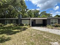 Charming single-story home with a stone chimney, well-manicured lawn, and inviting curb appeal at 1130 W Lake Brantley Rd, Altamonte Springs, FL 32714