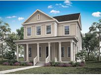 Inviting two-story home with a charming front porch and classic architectural details at 1969 Beach Ter, Celebration, FL 34747