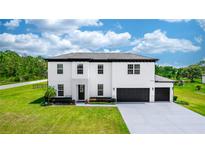 Stunning two-story home featuring a three-car garage and meticulously landscaped front yard at 20796 Quinn St, Orlando, FL 32833