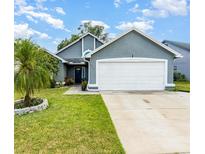 Charming home featuring a well-manicured lawn and a two-car garage at 2216 Grand Tree Ct, Lake Mary, FL 32746