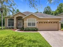 Charming single-story home featuring a two-car garage, manicured lawn, and tasteful landscaping at 2274 Foliage Oak Ter, Oviedo, FL 32766