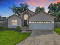 Charming single-Gathering home boasting a well-manicured lawn and a two-car garage at 2489 Tommys Turn, Oviedo, FL 32766