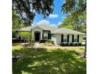 Charming single-story home featuring a manicured lawn and inviting front entrance at 2782 Cedar Knoll Dr, Apopka, FL 32712