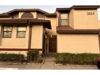 Beige two-story home with a well-manicured lawn and front door at 3024 S Semoran Blvd # 7, Orlando, FL 32822