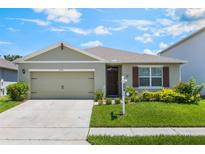 Charming one-story home with a well-manicured lawn, attached garage, and a welcoming front entrance at 3936 Silverstream Ter, Sanford, FL 32771