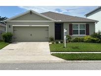 Charming single-story home featuring an attached two-car garage, manicured lawn, and beautiful exterior paint at 3936 Silverstream Ter, Sanford, FL 32771