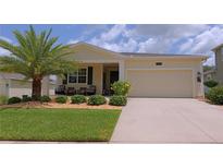 Charming single-story home with a well-manicured lawn and a welcoming front porch at 4858 Magnetite Loop, Mount Dora, FL 32757