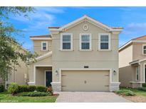 Charming two-story home with a two-car garage and well-maintained landscaping at 8955 Fluffy Lie Ct, Davenport, FL 33896