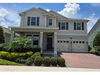 Beautiful two-story home with a landscaped front yard, attached two-car garage, and covered entryway at 9128 Sonoma Coast Dr, Winter Garden, FL 34787