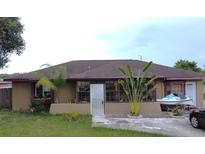 Cozy one-story home with tropical landscaping and a convenient driveway at 12207 Florida Woods Ln, Orlando, FL 32824