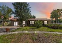 Charming home with a metal roof and beautiful landscaping at 14157 Louisville Ct, Orlando, FL 32826