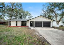 Charming renovated home with a two-car garage and a well-manicured lawn at 1523 N Beach St, Ormond Beach, FL 32174