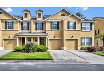 Charming townhome featuring a two-car garage, manicured lawn, and traditional architectural design at 1534 Barking Deer Cv, Casselberry, FL 32707