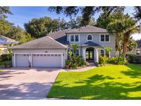 Charming two-story home featuring a three-car garage, beautiful landscaping, and a well-manicured lawn at 394 Baymoor Way, Lake Mary, FL 32746