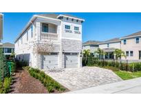 Charming two-story home featuring a two-car garage, balcony and a meticulously paved driveway at 421 Southfield St, Kissimmee, FL 34747