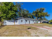 Charming single-story home with a fenced yard and mature trees providing shade at 4933 Balboa Dr, Orlando, FL 32808