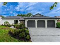 Charming single-story home with a three-car garage and well-manicured landscaping at 6019 Crystal View Dr, Orlando, FL 32819