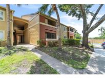 Charming condominium building with lush landscaping and well-maintained grounds at 664 Kenwick Cir # 104, Casselberry, FL 32707