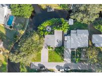 Stunning aerial view of a home with a backyard fire pit, waterfront access, a private dock, and a swimming pool at 6805 Barby Ln, Belle Isle, FL 32812