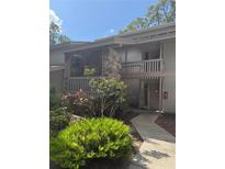 Charming two-story condo with stone accents and a well-maintained landscaped front yard at 116 Palm View Ct # 3535/6, Haines City, FL 33844