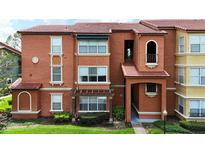 Attractive multi-story condo with red tile roof, well-maintained landscaping and stucco exterior at 5160 Conroy Rd # 21, Orlando, FL 32811