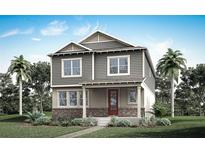 Charming two-story home with a brick foundation, gray siding, red door, and tropical landscaping at 532 Green Tracker Ave, Clermont, FL 34715