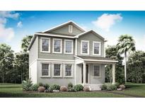 Inviting two-story home featuring a charming covered porch and lush landscaping for curb appeal at 540 Green Tracker Ave, Clermont, FL 34715
