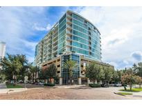 Stunning high rise with floor to ceiling glass windows and manicured landscaping at 101 S Eola Dr # 1021, Orlando, FL 32801
