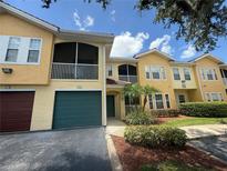 Inviting two-story condo with a screened balcony and a well-maintained landscaped front yard at 12016 Villanova Dr # 102, Orlando, FL 32837