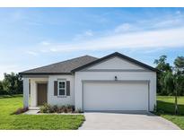 Charming one-story home featuring a two-car garage, manicured lawn, and welcoming front entrance at 1343 Dalkeith Cv, Sanford, FL 32771