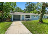 Charming single-story home with a quaint carport and lush green lawn at 167 S Sheridan Ave, Deland, FL 32720