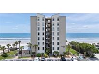 Oceanfront condo building featuring a beautiful beachfront view and well-maintained landscaping at 2121 Hill St # 7B, New Smyrna Beach, FL 32169