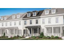 Charming two-story townhome with covered porch and manicured landscaping at 2386 Celebration Blvd, Celebration, FL 34747