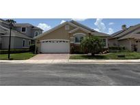 Charming single-story home with a brick driveway, two-car garage, and well-maintained landscaping at 2622 Clarinet Dr, Orlando, FL 32837
