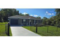 Charming single-story home featuring a well-maintained lawn and a cozy front porch at 35 Olive Cir, Ocala, FL 34472