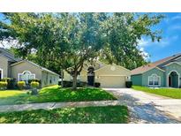 Charming single-Gathering home featuring a lush, green front yard and a well-maintained lawn at 500 Wellesly St, Oviedo, FL 32765