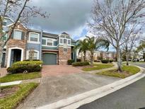 Charming townhome with a brick driveway, a garage, and colorful exterior paint at 506 Terrace Spring Dr, Orlando, FL 32828