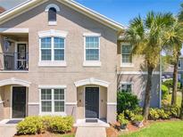 Inviting condo exterior with a stucco facade, neat landscaping, and a charming entrance at 6524 Swissco Dr # 1012, Orlando, FL 32822