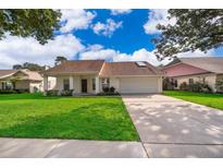 Charming single-story home with a well-manicured lawn and a two-car garage at 1017 Gould Pl, Oviedo, FL 32765