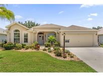 Charming single-story home with well-manicured lawn and lush landscaping in a desirable community at 1254 Spartanburg Way, The Villages, FL 32162