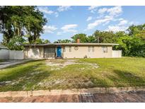 Charming single-story home with an attached garage and quaint landscaping in a residential neighborhood at 131 N Central Ave, Apopka, FL 32703